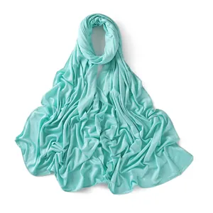 Close-up of mint green jersey scarf showing soft modal fabric and fine edge stitching