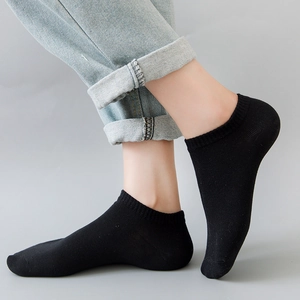 Unisex black low cut invisible cotton boat socks shown on foot with denim jeans