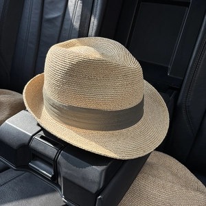 Classic straw fedora hat with green ribbon band for sun protection and outdoor travel
