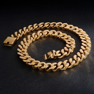 Close-up of a bold gold-plated curb chain necklace with a box clasp on black background