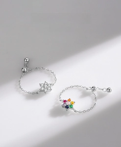 Detailed macro view of S925 sterling silver chain rings with sparkling floral zircon motifs
