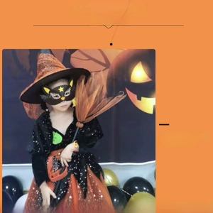 Detail view of kids Halloween witch costume with orange star mesh skirt and matching broom