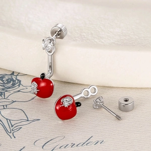 Sweet red apple stud earrings with silver accents and sparkling crystals on garden background