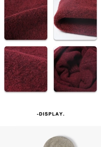 Detail of burgundy knit fabric texture showing thick ribbed weave and soft material