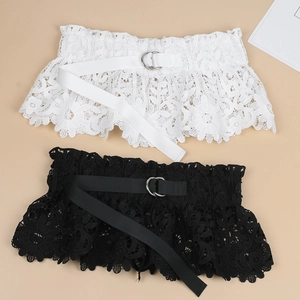 Detailed view of floral lace waist belts in black and white with metal D-ring buckles