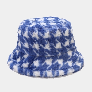 Detailed close-up of blue and white houndstooth pattern on plush faux fur bucket hat