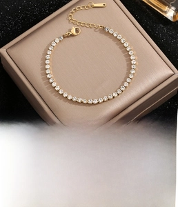 Close-up of gold-plated titanium steel tennis bracelet with sparkling cubic zirconia