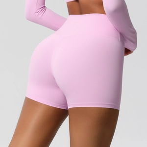 Detail view of pink high-waist fitness shorts featuring seamless lift and squat-proof fabric