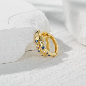 Detailed macro shot of S925 sterling silver hoop earrings with multicolor zircon stones