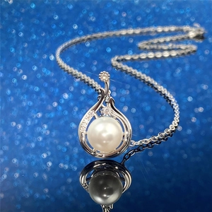 Baroque style faux pearl necklace with silver metal pendant and sparkling crystal accents