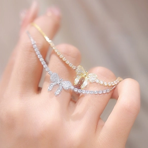 Detail of silver and gold butterfly bracelets with micro-pave zircons on a model wrist