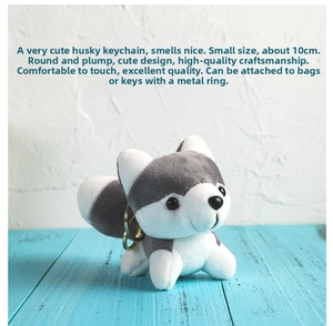 Close-up of 10cm Husky plush keychain with golden metal hook on blue wood floor