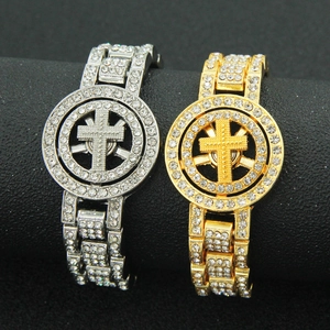 Iced-out hip hop watch-style bracelet with rotating cross charm in gold and silver finish
