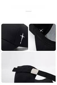 Macro shot of white cross embroidery and metal buckle adjustment on black cotton cap