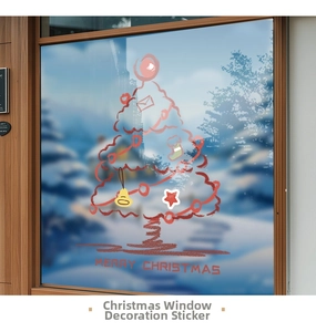 Detail of red Christmas tree window decal with festive stars and Merry Christmas text