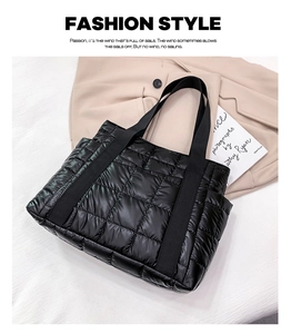 Macro detail of black quilted tote bag with shiny nylon material and padded texture