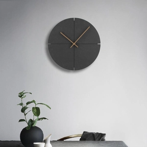 Detail of dark grey wall clock with concrete texture and minimalist wooden hands