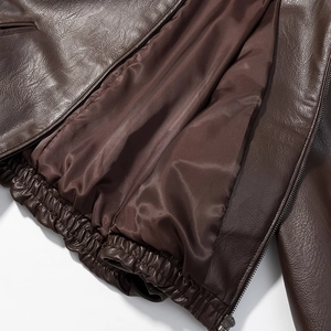 Detail of elastic hem and smooth lining on a premium deep brown leather jacket