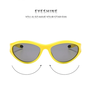 Close-up of bright yellow aerodynamic frames and grey lenses on Y2K sports sunglasses