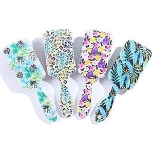 Four rectangular plastic air cushion hairbrushes with tropical leaves and leopard patterns