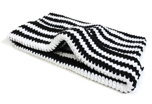 Detailed macro view showing the thick texture of a black and white striped crochet beanie