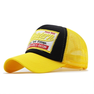 Detail of vintage 1985 Western embroidery and yellow mesh on a retro trucker cap