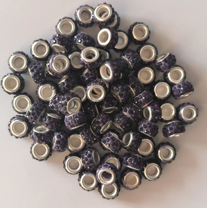 Close-up of sparkling purple pave crystal beads with silver eyelet for jewelry making