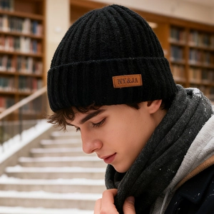Men's black rib-knit winter beanie with brown leather logo patch for cold weather