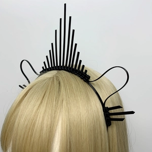 Detail of creative black halo crown headpiece with spiked zip tie pattern for hair