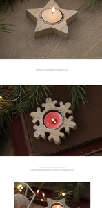 Close-up of snowflake and star shaped wooden candle holders with warm festive decor
