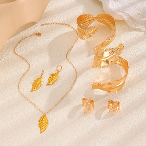Detailed close-up of a 6-piece golden leaf jewelry set featuring fine vein textures