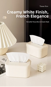 Close-up of cream white tissue box featuring vertical striped texture and modern design