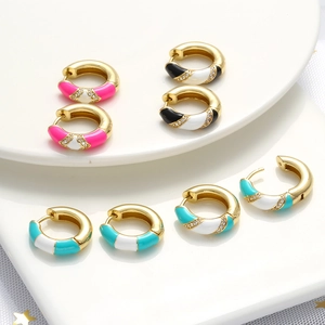 Detail of colorful enamel hoop earrings with gold plating and sparkling zircon accents