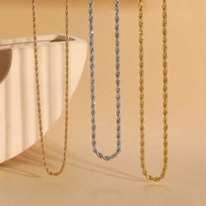 Classic 18K gold and silver rope chains displayed with elegant ceramic decor
