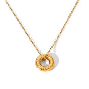 Detail showing 18K gold starburst pendant with hammer texture and sparkling zircons