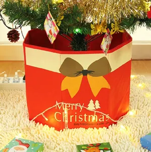 Red non-woven Christmas tree collar with yellow bow and Merry Christmas text decor