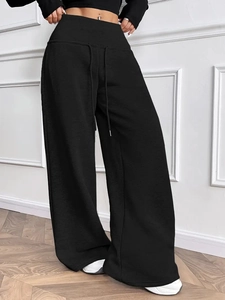 Women's casual black wide leg trousers with elastic drawstring waist on model