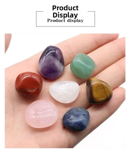 Polished natural chakra stones held in palm showing size and smooth texture