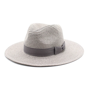 Close-up of grey straw fedora hat featuring wide brim and elegant dark grey ribbon bow
