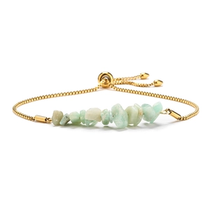 Detail of adjustable gold box chain bracelet with natural light green and blue crystal stones