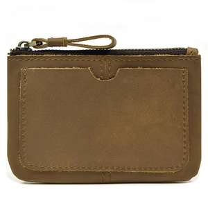 Detailed view of brown leather coin purse showing premium texture and front card slot