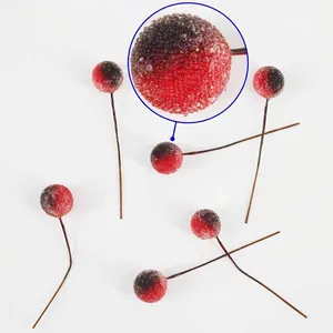 Macro detail of red frosted artificial berries with snowy texture for Christmas DIY decor
