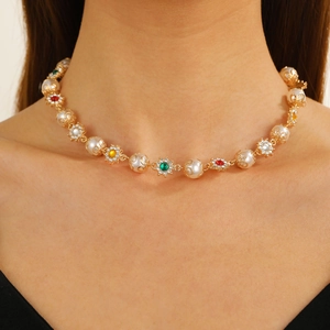 Gold hip hop necklace with pearls and colorful crystals on model close-up view