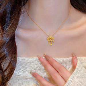 French vintage gold plated necklace with firework floral pendant on model