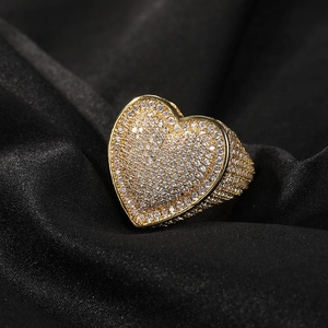 Detail of a hip-hop heart ring with gold plating and sparkling zircon micro-paving