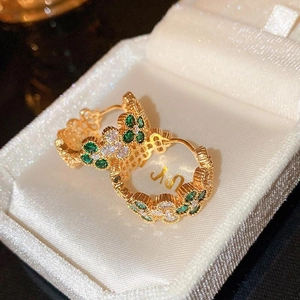 Vintage style gold clover earrings with green stones in white velvet jewelry box