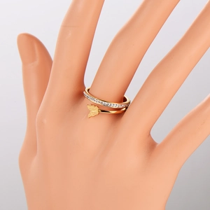 Golden butterfly double ring with white diamonds on a minimalist display model