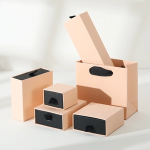 Detailed set of matte salmon pink drawer jewelry boxes and matching gift bag in a modern style