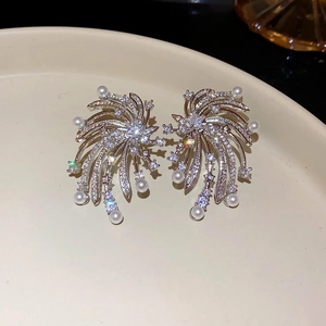 Macro detail of firework pearl earrings with silver finish and micro-set cubic zirconia