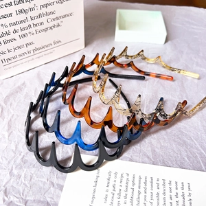 Detailed close-up of colorful wavy headbands in assorted textures and patterns